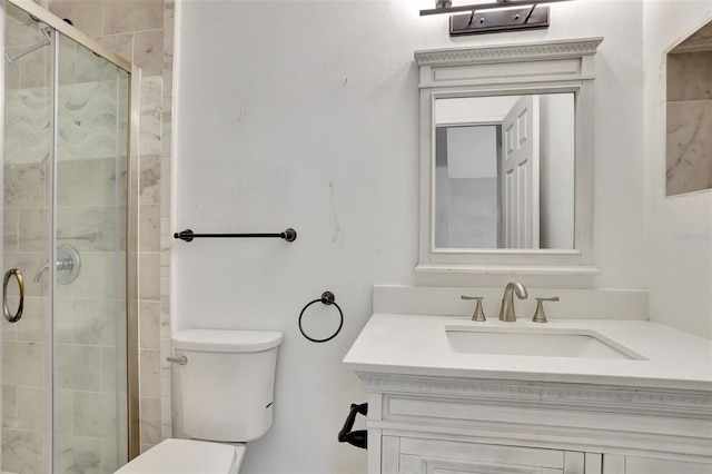 full bathroom featuring toilet, a stall shower, and vanity