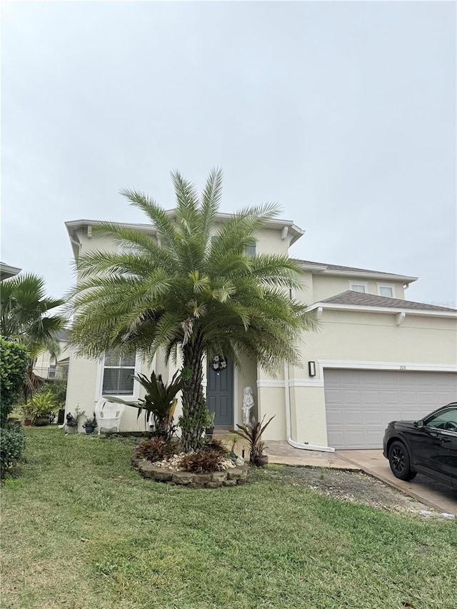 view of property hidden behind natural elements with a garage and a front yard