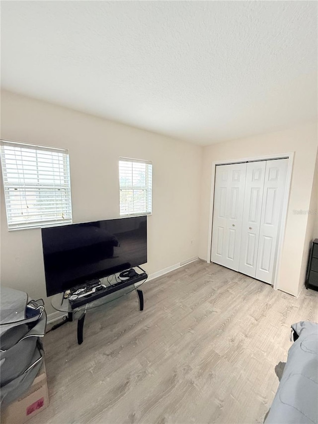 office with light hardwood / wood-style floors and a textured ceiling