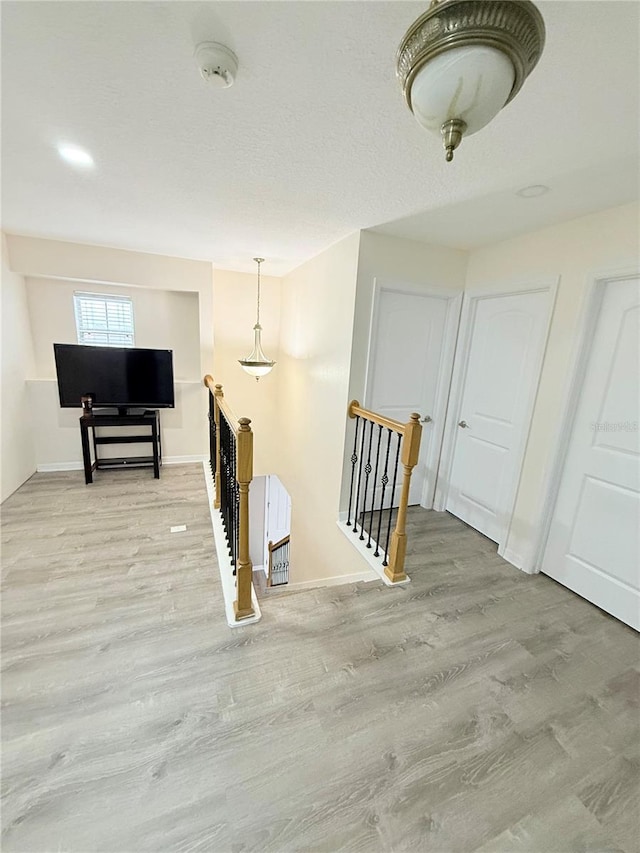 hall with light hardwood / wood-style flooring