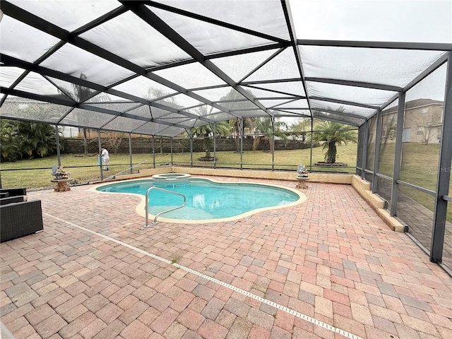 view of swimming pool featuring glass enclosure, an in ground hot tub, a patio area, and a lawn