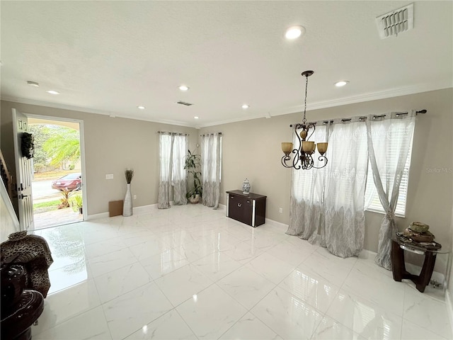 interior space with crown molding and a chandelier