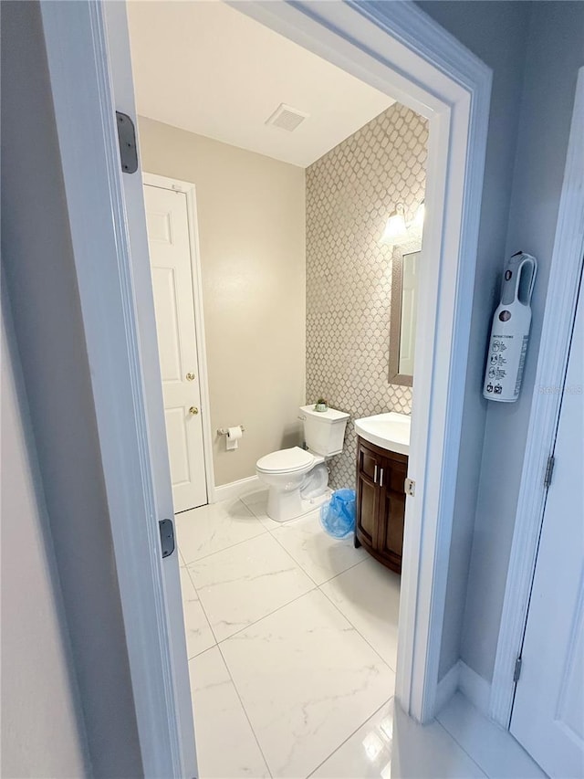 bathroom with toilet and vanity