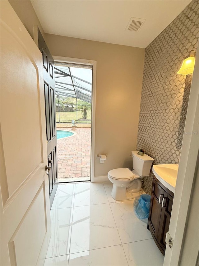 bathroom featuring toilet and vanity