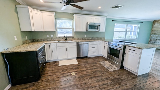 kitchen with sink, white cabinetry, appliances with stainless steel finishes, and kitchen peninsula