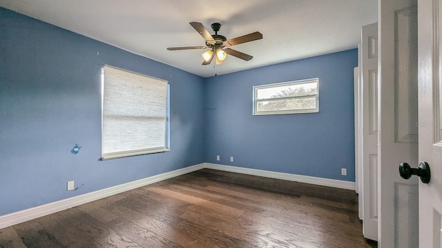 empty room with ceiling fan and dark hardwood / wood-style floors