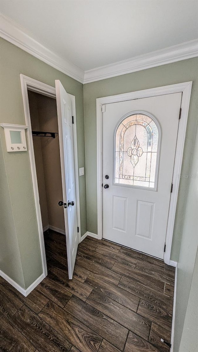 entryway with dark wood-type flooring and ornamental molding