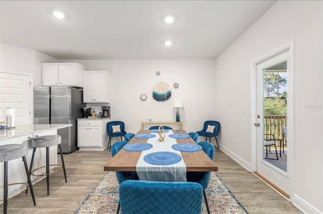 dining space with light hardwood / wood-style floors