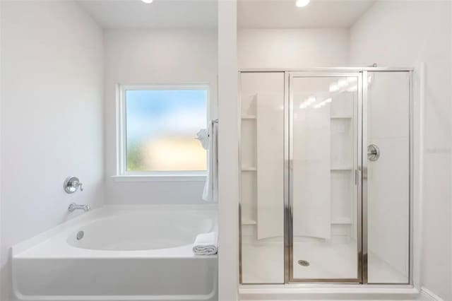 bathroom featuring independent shower and bath