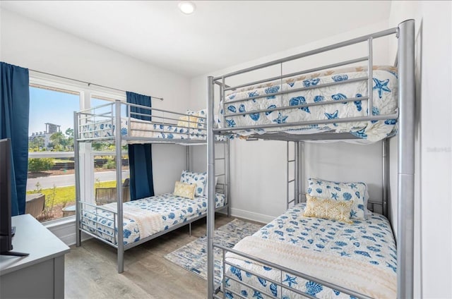 bedroom featuring multiple windows and hardwood / wood-style floors