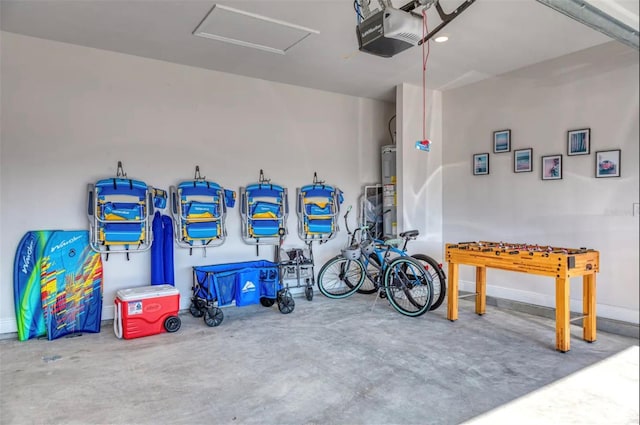 garage featuring a garage door opener and water heater