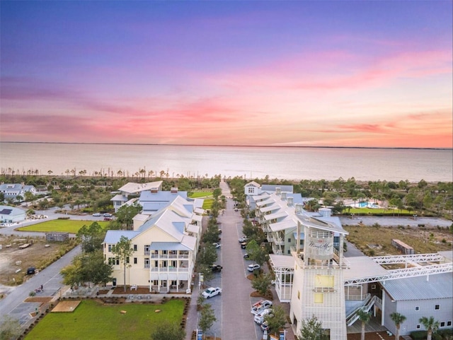 aerial view at dusk with a water view