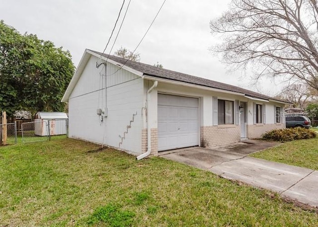 garage featuring fence and driveway