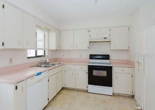 kitchen featuring light countertops, white appliances, a sink, and white cabinetry