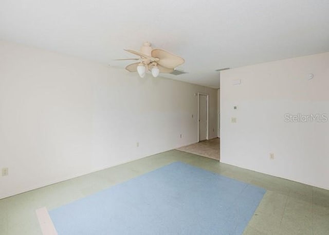 spare room featuring ceiling fan and visible vents