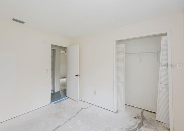 unfurnished bedroom featuring a closet and visible vents