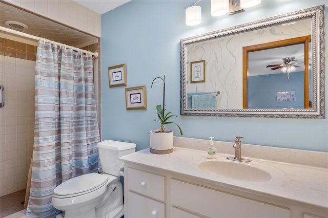 bathroom with ceiling fan, curtained shower, toilet, and vanity