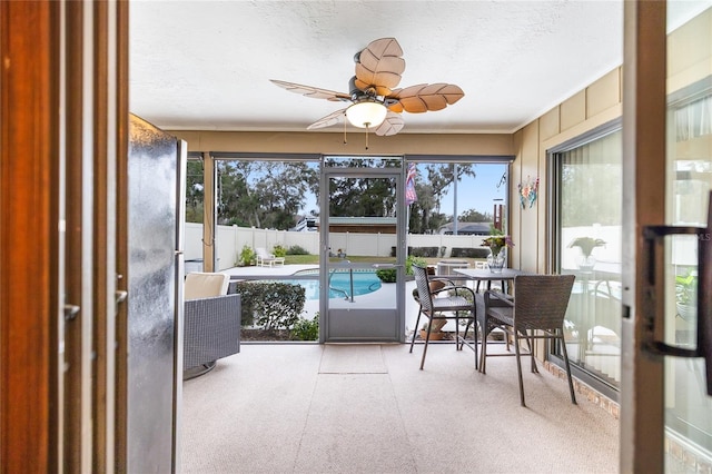 sunroom featuring ceiling fan