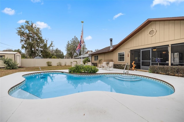 view of swimming pool featuring a storage unit and a patio area