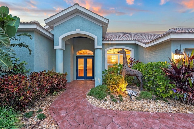 exterior entry at dusk with french doors