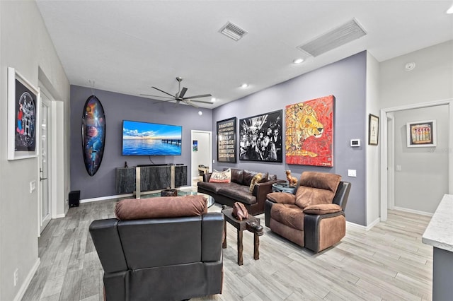 cinema featuring ceiling fan and light wood-type flooring