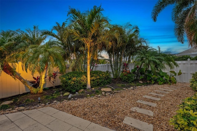 yard at dusk featuring a patio