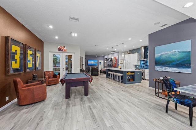 rec room featuring pool table, light hardwood / wood-style floors, and french doors