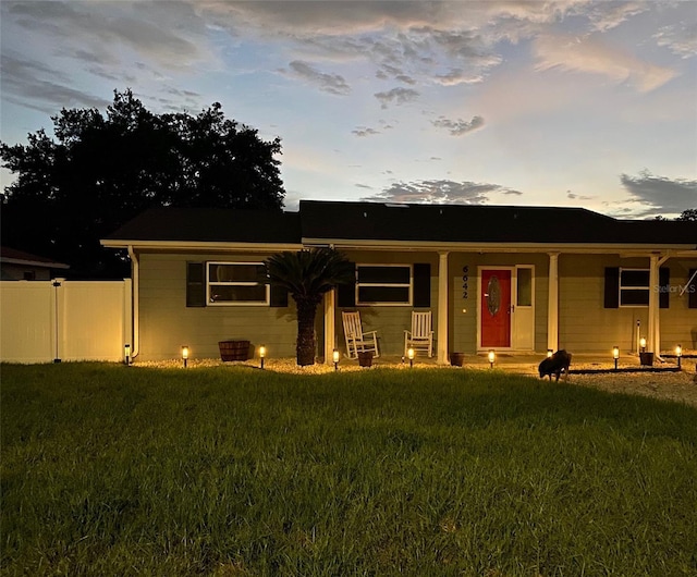 view of front facade featuring a yard and covered porch