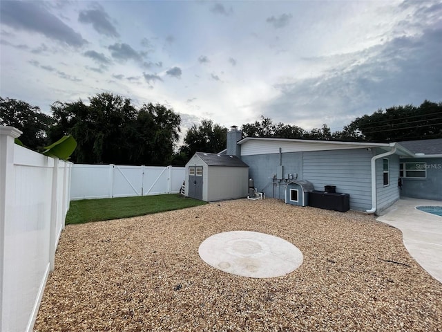 view of yard featuring a storage shed and a patio