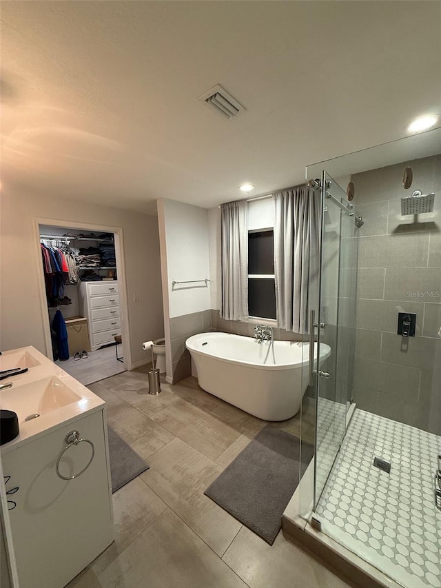 bathroom with vanity, shower with separate bathtub, and tile patterned floors