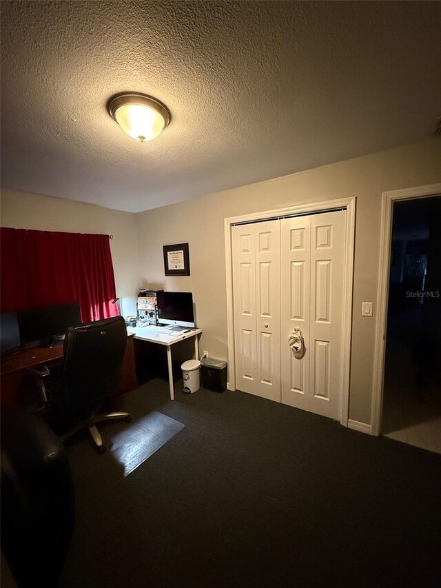 home office with carpet floors and a textured ceiling