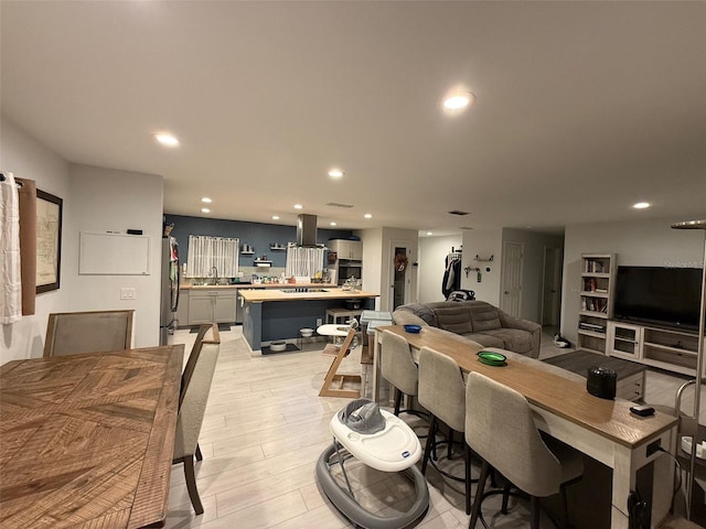 dining room featuring sink and light wood-type flooring