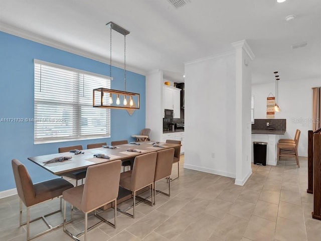 tiled dining room with crown molding