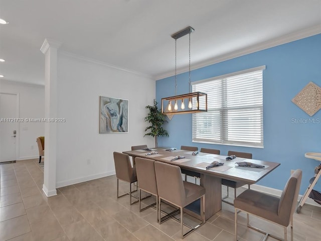 dining room featuring crown molding and light tile patterned floors