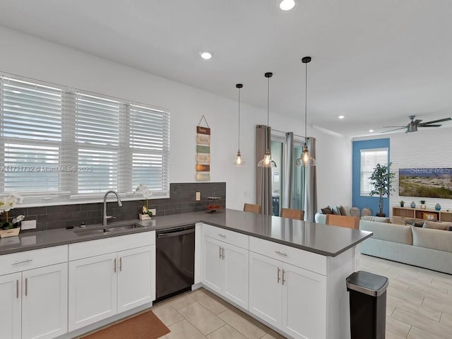 kitchen featuring pendant lighting, white cabinets, dishwasher, sink, and kitchen peninsula