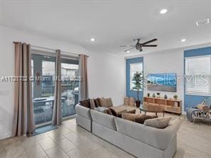 living room with ceiling fan and plenty of natural light