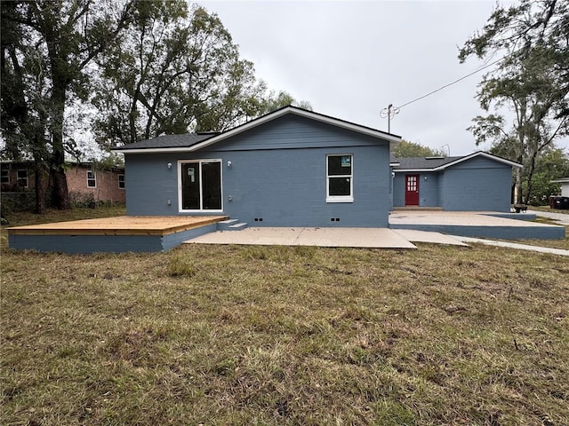 rear view of house featuring a yard, a deck, and a patio area