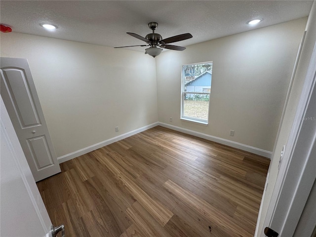 unfurnished room featuring ceiling fan, hardwood / wood-style floors, and a textured ceiling