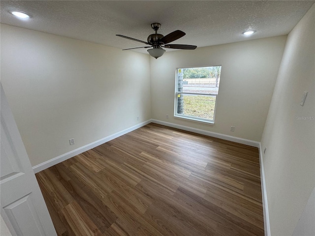 spare room with ceiling fan, wood-type flooring, and a textured ceiling