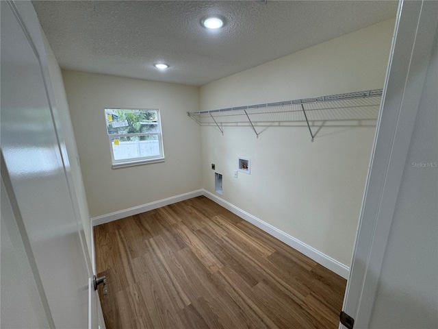 laundry room featuring hardwood / wood-style flooring, washer hookup, a textured ceiling, and electric dryer hookup