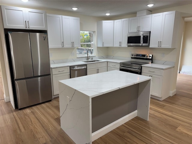 kitchen with white cabinetry, appliances with stainless steel finishes, and sink