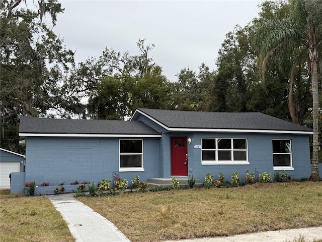 ranch-style home with a front lawn