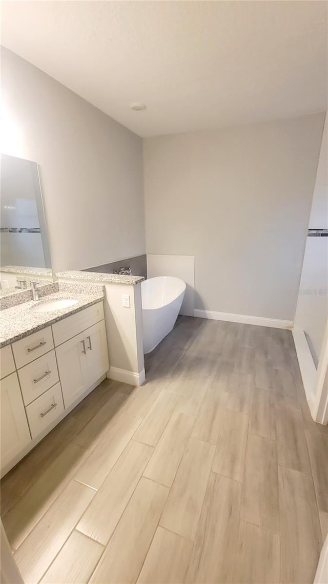 bathroom featuring a tub and vanity