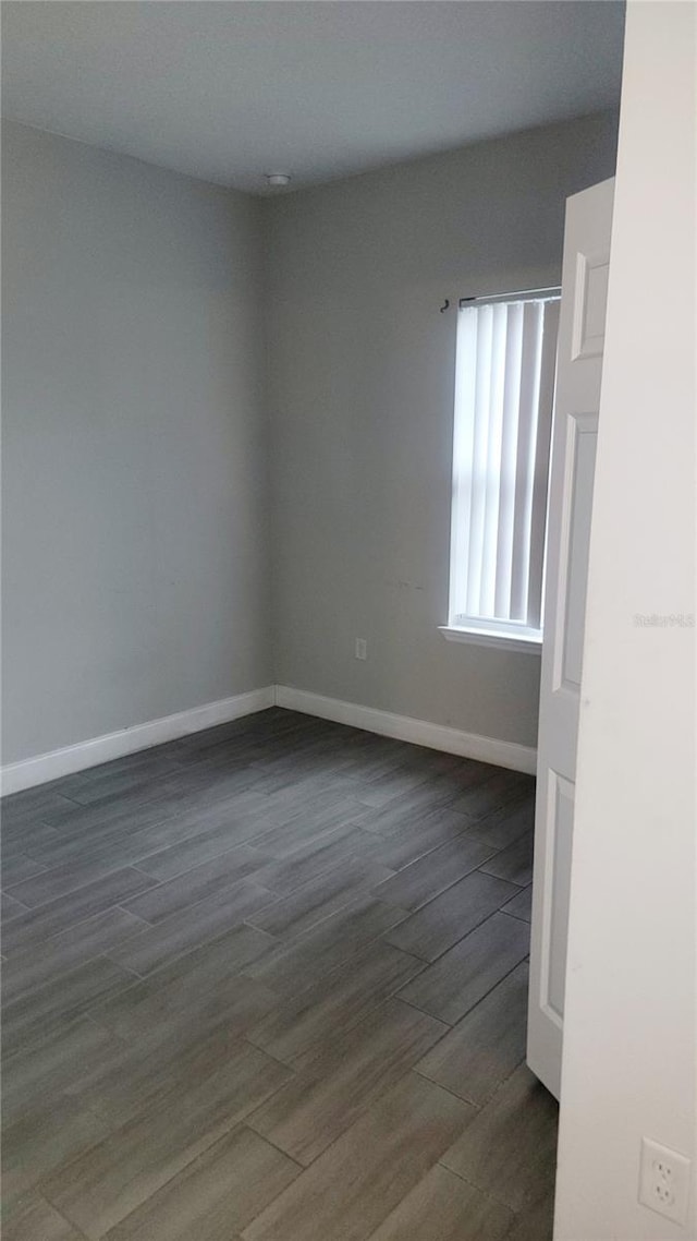 empty room with dark hardwood / wood-style floors