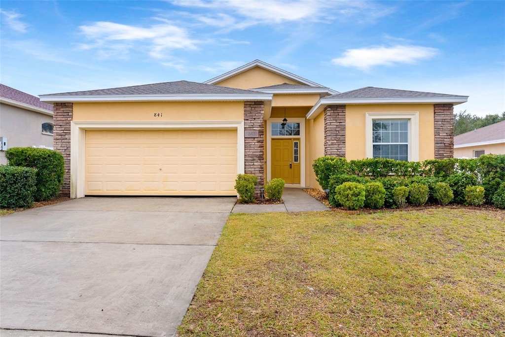 view of front of home featuring a garage and a front lawn