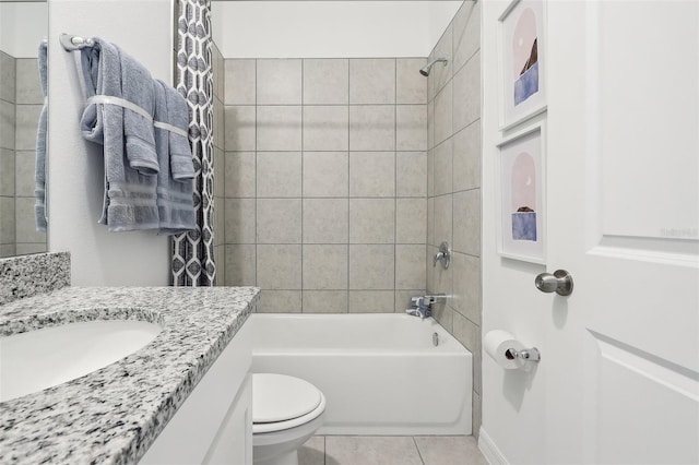 full bathroom featuring toilet, vanity, tiled shower / bath, and tile patterned flooring