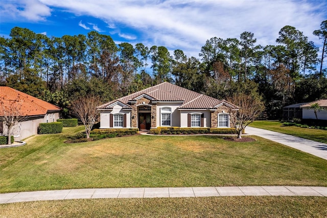 mediterranean / spanish-style house featuring a front yard