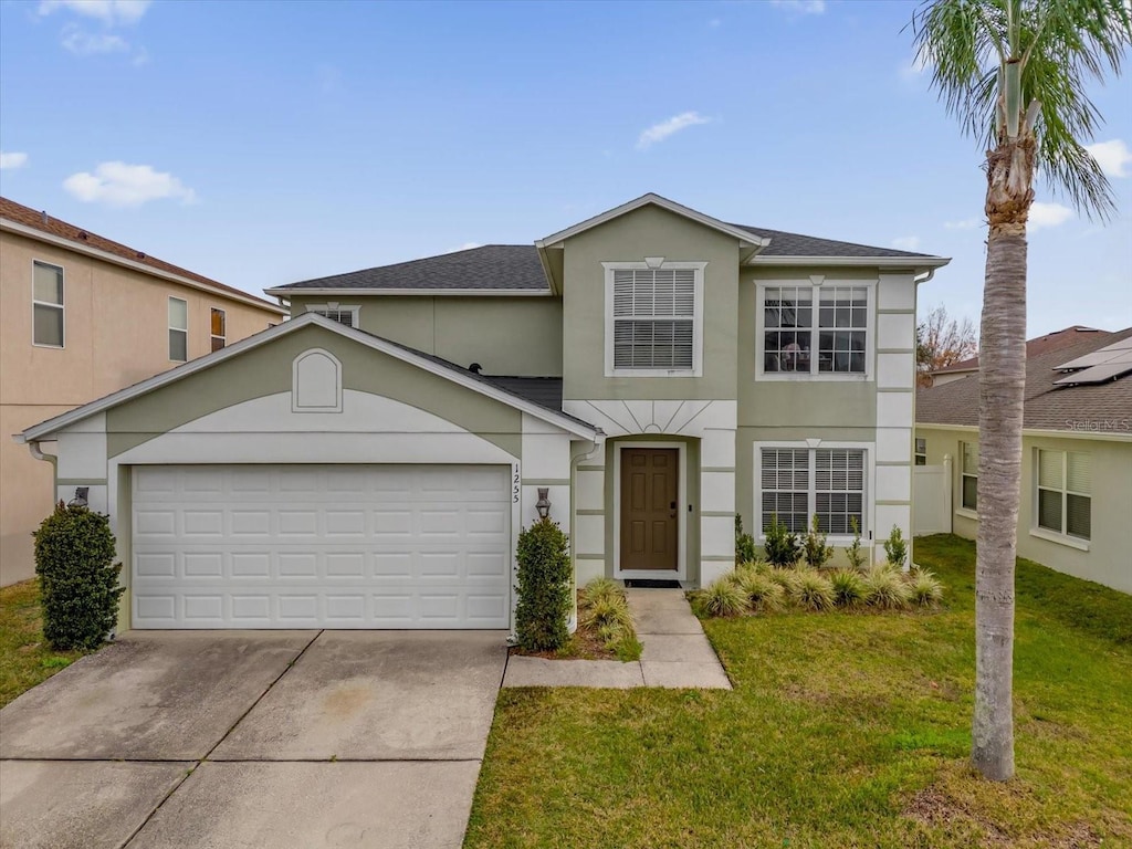 front of property featuring a garage and a front lawn