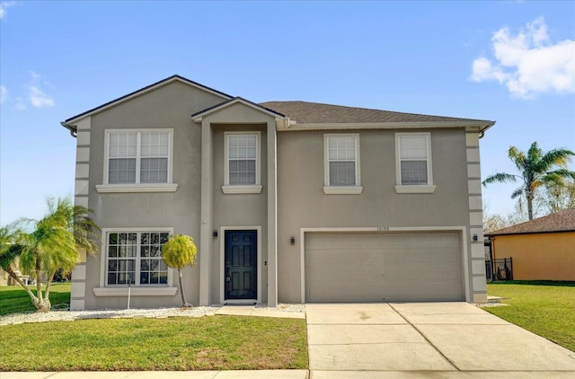 view of front of home featuring stucco siding, a front yard, a garage, and driveway