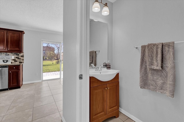 bathroom with tile patterned floors, a textured ceiling, decorative backsplash, baseboards, and vanity